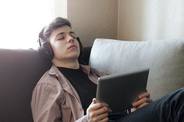 teenager in headphones listening to music