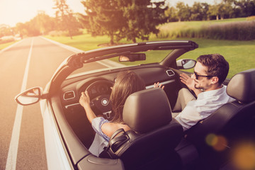 Friends, friendship, destination, auto vehicle rent, escape, speed ride. Rear back shot of carefree...