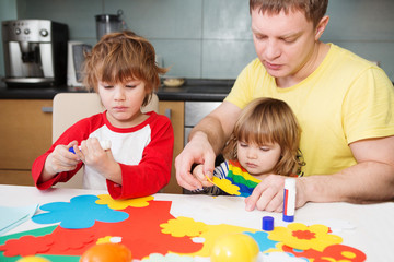 Obraz premium father and the children prepare together Paper decor. children's creativity. Tools and materials for children's art creativity on table. Easter decor.