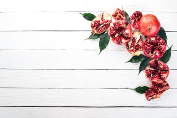 Pomegranate. On a white wooden background. Top view. Copy space.