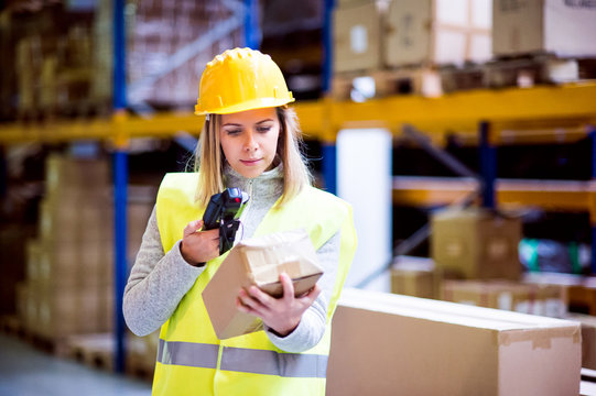 Warehouse woman worker with barcode scanner.