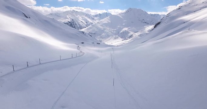 Drone shot of amazing winter mountain view over a ski resort in the Swiss Alps