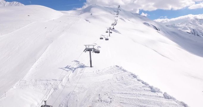 Drone shot of an alpine resort in Andermatt. Ski lifts in operation in winter