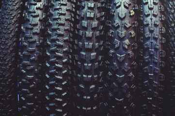 The tires on the bicycle wheel are in a row. selling a piece of mountain bike tires in closeup