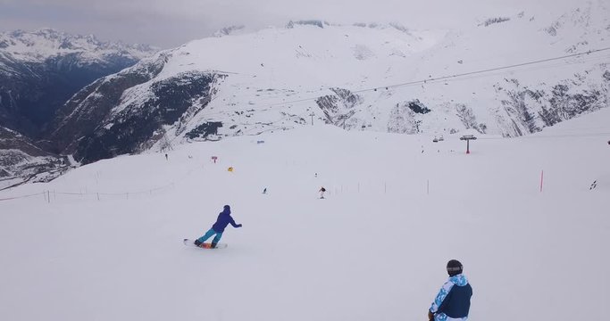 Tourists ski down the slopes of a mountain resort in Andermatt during winter