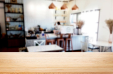 Selected focus empty brown wooden table and Coffee shop or restaurant blur background with bokeh image. for your photomontage or product display.