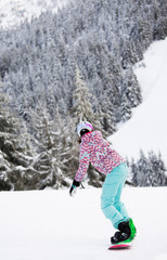 Fototapeta na wymiar Woman on snowboard in mountains