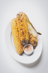 grilled corn with cocktailsauce on a wooden background