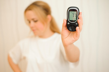 glucometer with result of measurement sugar level and tape measure, concept of diabetes
