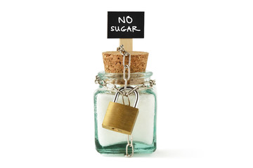 Sugar jar wrapped in metal chain and padlock - No sugar diet concept