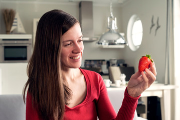 schlanke Frau hat Hunger auf leckere Erdbeere