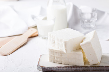 Fresh cottage cheese on rustic white wooden board
