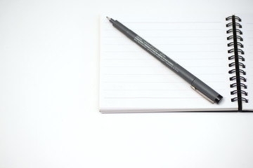 notebook and pen on White background