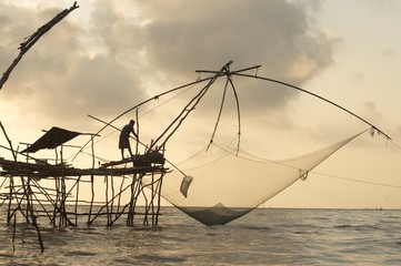 Twilight view of square dip net or Yo made of bamboo in sunset time at Ban Pak Pra -Talay Noi Lake, Phatthalung, Thailand.