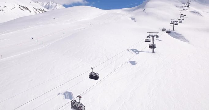 Aerial shot above a ski lifts in a ski resort in Andermatt during winter