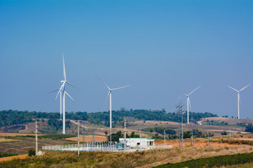 Fototapeta na wymiar Wind turbines under the blue sky. Wind turbines generating electricity.