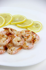 seafood. shrimp on a plate with lemon.