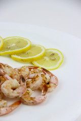 seafood. shrimp on a plate with lemon.