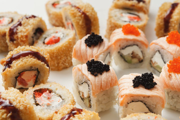 Closeup of sushi rolls on white background