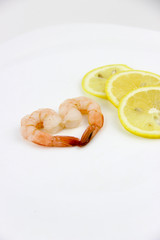 seafood. shrimp on a plate with lemon.
