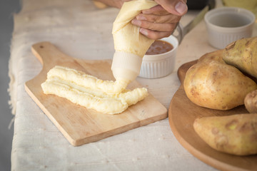 Mashed potatoes in a plate on a wooden table