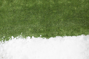 Meeting snow on green grass close up - between winter and spring concept background - Powered by Adobe
