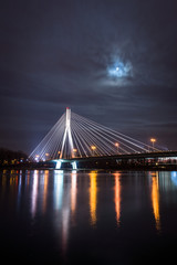 Fototapeta na wymiar Swietokrzyski bridge over the Vistula river at night in Warsaw, Poland