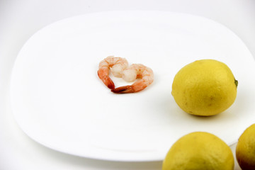 seafood. shrimp on a plate with lemon.