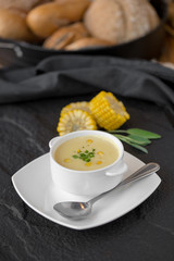 Corn soup in white cup on a table