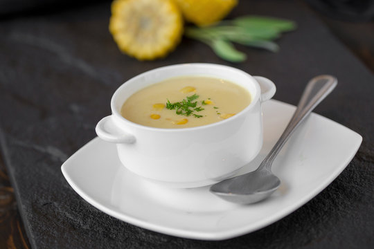 Corn soup in white cup on a table