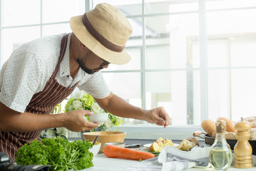 Man cooking Fresh salad of potatoes with carrot with vegetables
