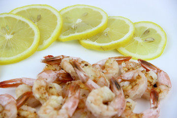 seafood. shrimp on a plate with lemon.