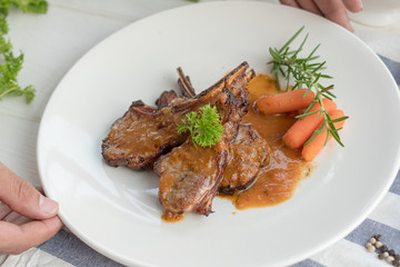 Rack of Lamb with Grilled Peach on white dish