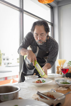 Handsome bearded cheef cook prepairing spaghetti on a kitchen, Chef cooks meal