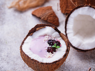 Fototapeta na wymiar Blackberries smoothie in coconut shell
