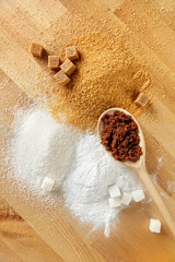 Fototapeta na wymiar Sugar. White Sugar And Brown Sugar On Wood Background