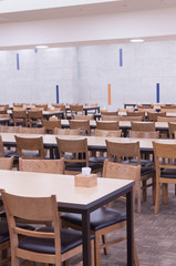 Classic wooden tables and chairs set arrange in convention hall, food court table set prepare for people