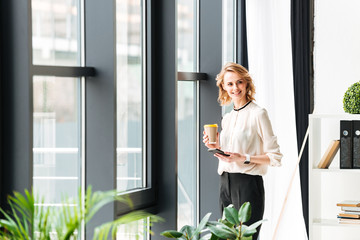 Young business woman in office looking aside chatting