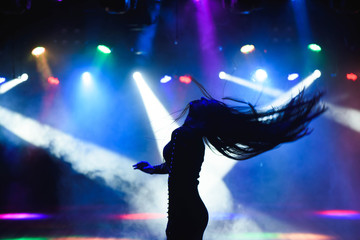 dancing silhouette of girl in a nightclub