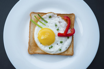fried egg on toast with sage pepper