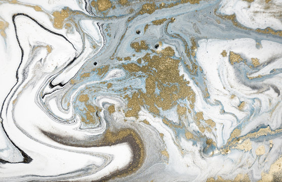 Marble abstract acrylic background. Nature marbling artwork texture. Golden glitter.