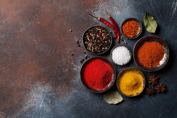 Obraz na płótnie Canvas Colorful spices on stone table