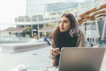 Young beautiful caucasian purple grey hair woman sitting outdoor using technological devices smiling - business, creativity, break concept