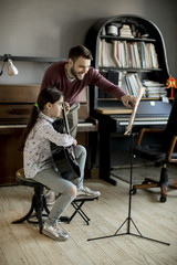 Cute little girl with guitar teacher