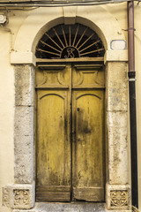 Fototapeta na wymiar Old wooden door in Cefalu in Sicily, Italy