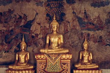 Ancient Buddha sculptures at Wat Uposatharam Temple or Wat Bot at noon under clear blue sky, Thailand