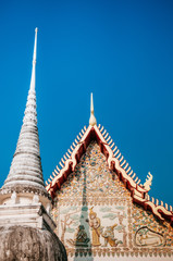 Fototapeta premium Wat Uposatharam Temple or Wat Bot at noon under clear blue sky, Thailand