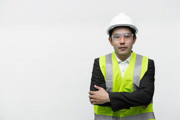 Asian engineer with wear helmet and safety glasses,He has a walkie talkie in hand,Thailand smart people