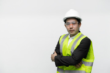 Asian engineer with wear helmet and safety glasses,He has a walkie talkie in hand,Thailand smart people