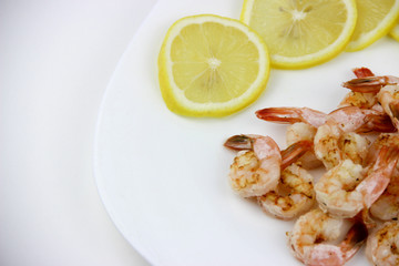 seafood. shrimp on a plate with lemon.